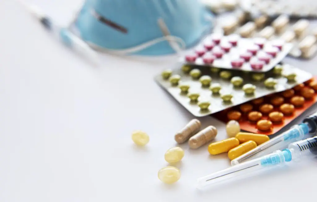 blue medical mask and medicine pills 2411855 blue medical mask and medicine pills 2411855